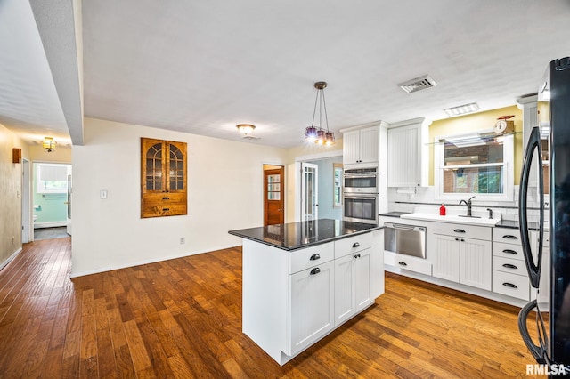 21016 N US Highway 24, Canton, IL 61520 - kitchen with visible vents, a sink, a kitchen island, stainless steel appliances, and white cabinets