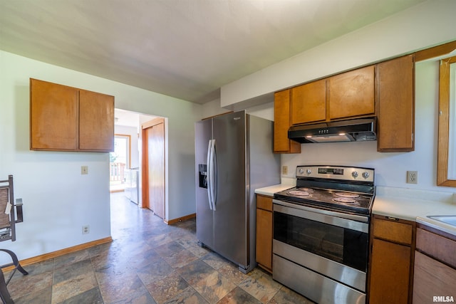 kitchen with stainless steel appliances, under cabinet range hood, light countertops, and brown cabinetry
