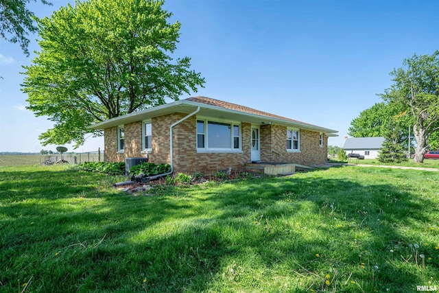 view of front of house featuring brick siding and central air condition unit
