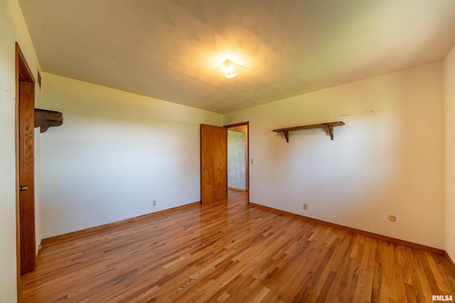 unfurnished bedroom featuring light wood finished floors and baseboards