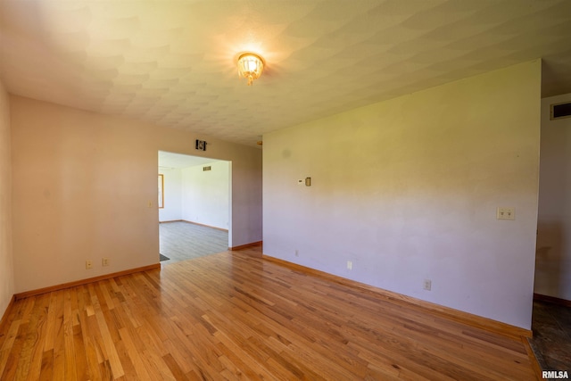 unfurnished room featuring light wood-style floors and baseboards