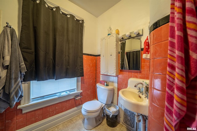 1624 W Barker Ave, Peoria, IL 61606 - bathroom featuring toilet, tile walls, and wainscoting