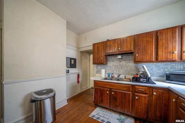 1624 W Barker Ave, Peoria, IL 61606 - kitchen featuring stainless steel microwave, dark wood-style flooring, light countertops, and tasteful backsplash
