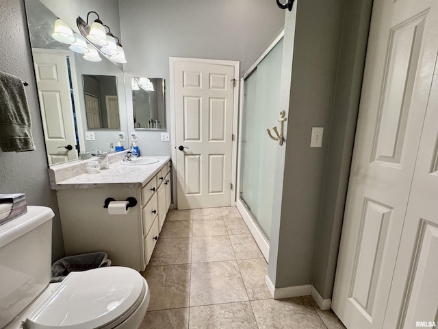 bathroom with toilet, a stall shower, vanity, tile patterned flooring, and baseboards