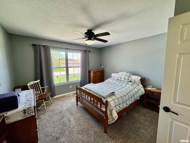 carpeted bedroom featuring a ceiling fan, a textured ceiling, and baseboards