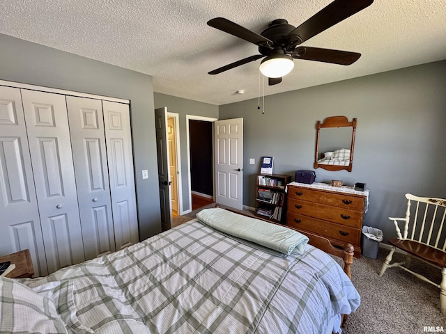 bedroom featuring carpet, a closet, a textured ceiling, a ceiling fan, and baseboards