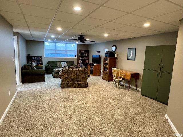 living area featuring carpet, baseboards, recessed lighting, and a paneled ceiling