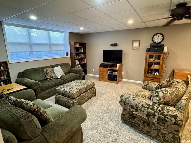 carpeted living area featuring baseboards, recessed lighting, a drop ceiling, and a ceiling fan