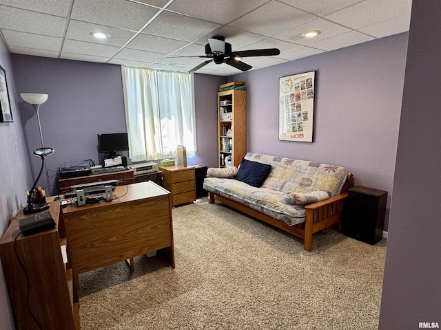 office area featuring light carpet, ceiling fan, and a drop ceiling