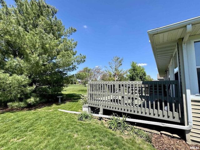 view of green lawn with a deck
