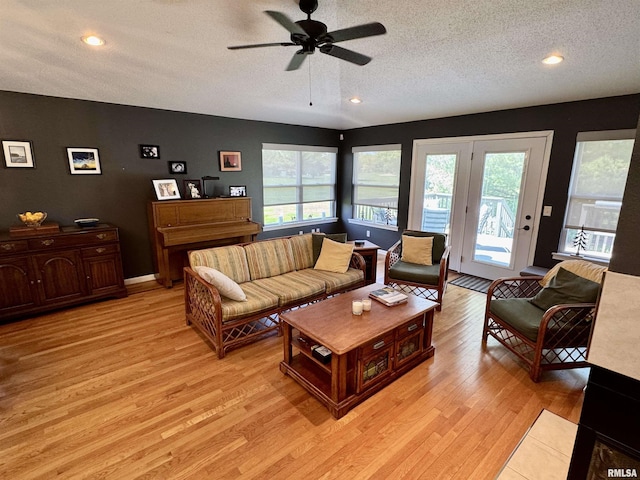 living area with plenty of natural light, a textured ceiling, light wood-style floors, ceiling fan, and recessed lighting