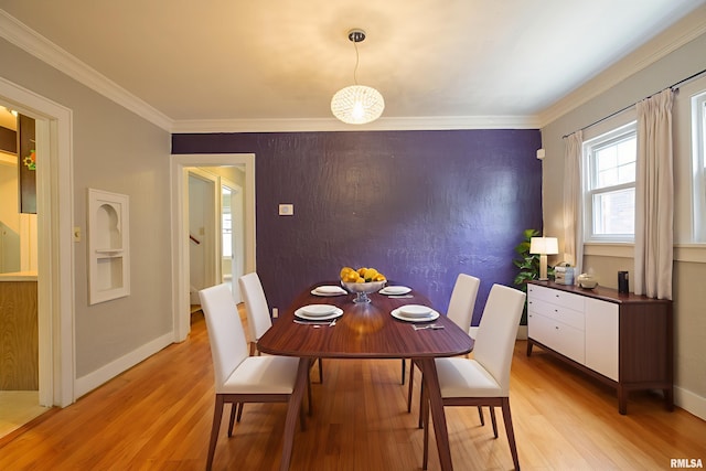 606 W Maywood Ave, Peoria, IL 61604 - dining space featuring light wood finished floors and crown molding
