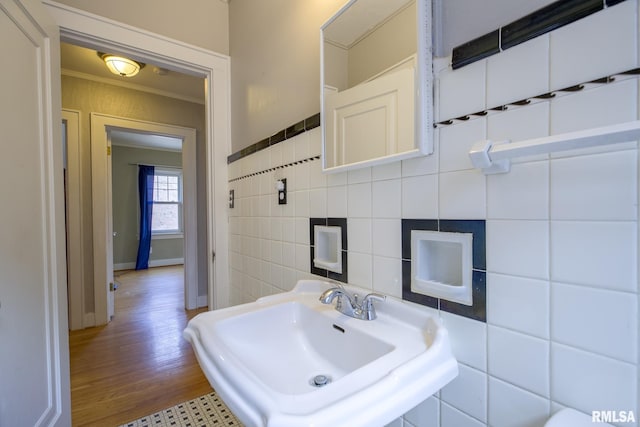 606 W Maywood Ave, Peoria, IL 61604 - bathroom featuring tile walls, ornamental molding, and wood finished floors