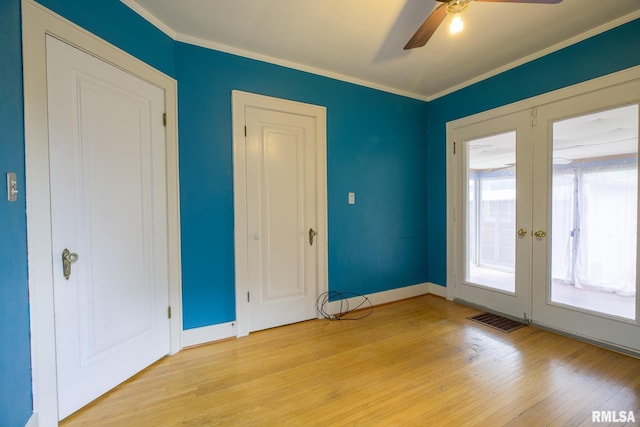 606 W Maywood Ave, Peoria, IL 61604 - spare room featuring a ceiling fan, light wood-type flooring, french doors, and crown molding