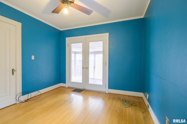 606 W Maywood Ave, Peoria, IL 61604 - spare room featuring french doors, crown molding, wood finished floors, and a ceiling fan