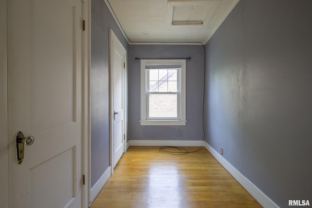 606 W Maywood Ave, Peoria, IL 61604 - unfurnished bedroom featuring light wood finished floors, attic access, and crown molding