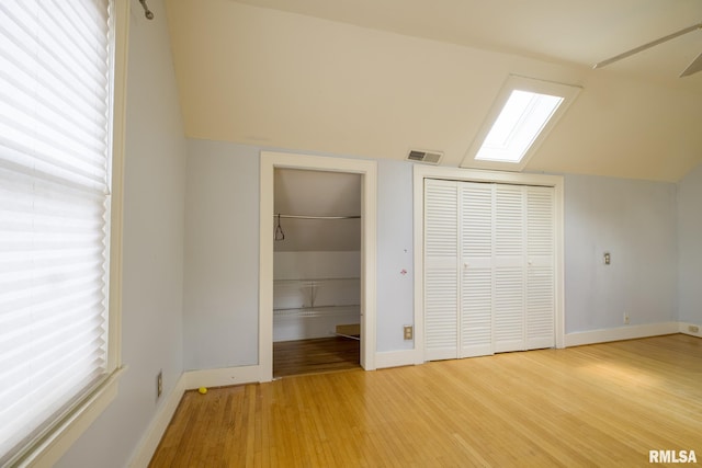 606 W Maywood Ave, Peoria, IL 61604 - unfurnished bedroom featuring light wood finished floors, a skylight, and vaulted ceiling