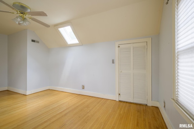 606 W Maywood Ave, Peoria, IL 61604 - additional living space featuring vaulted ceiling, wood finished floors, a ceiling fan, and a skylight