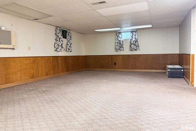 606 W Maywood Ave, Peoria, IL 61604 - below grade area featuring a drop ceiling, carpet flooring, wainscoting, and wood walls