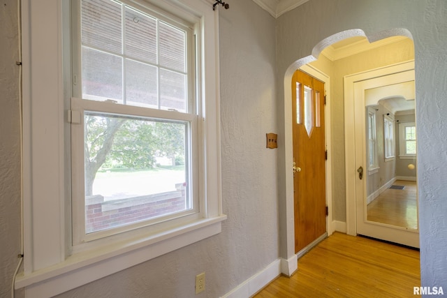 606 W Maywood Ave, Peoria, IL 61604 - hall with light wood-type flooring, ornamental molding, arched walkways, and a textured wall