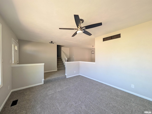 unfurnished room with ceiling fan, baseboards, and carpet floors