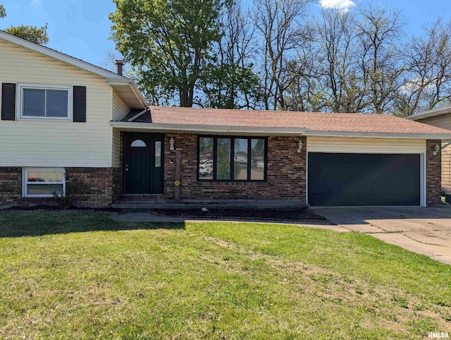 split level home with an attached garage, brick siding, concrete driveway, and a front yard