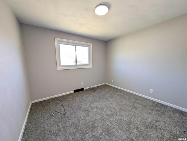 carpeted spare room with baseboards