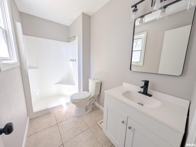 bathroom with baseboards, toilet, a shower, vanity, and tile patterned flooring