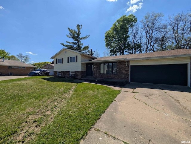 split level home with concrete driveway, an attached garage, a front yard, and brick siding