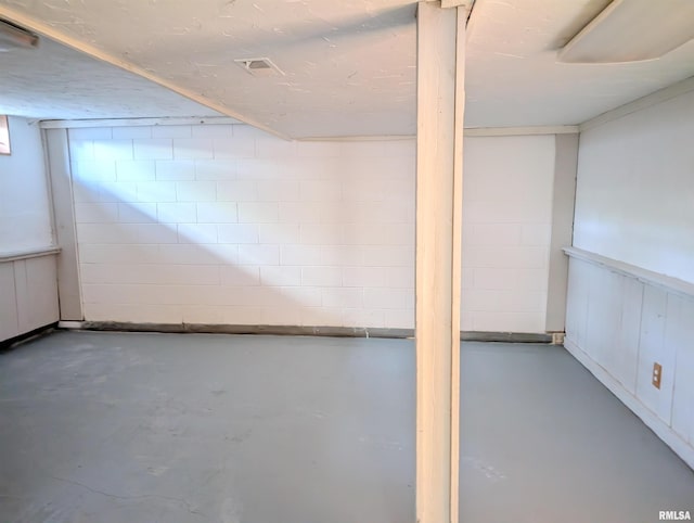 finished basement with concrete block wall