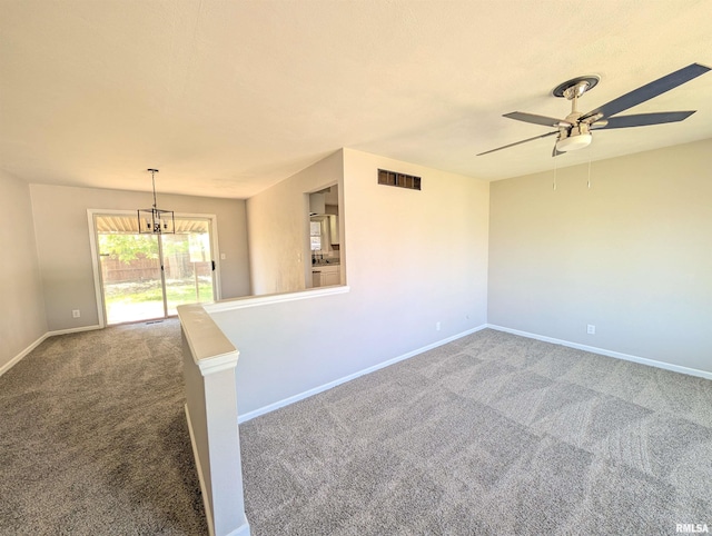 empty room with carpet flooring, ceiling fan, and baseboards