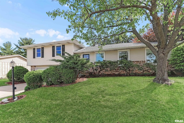408 N Ohio Ave, Morton, IL 61550 - tri-level home featuring a front lawn, brick siding, and a garage