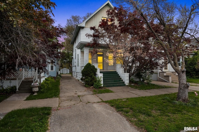 1803 W Barker Ave, Peoria, IL 61606 - view of front of home featuring asphalt driveway, stairway, board and batten siding, and a porch
