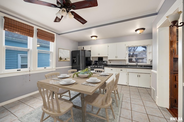 1803 W Barker Ave, Peoria, IL 61606 - dining space with light tile patterned flooring, a ceiling fan, and baseboards