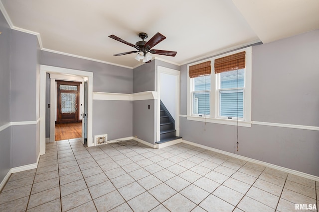 1803 W Barker Ave, Peoria, IL 61606 - unfurnished room featuring a ceiling fan, light tile patterned flooring, stairway, baseboards, and crown molding