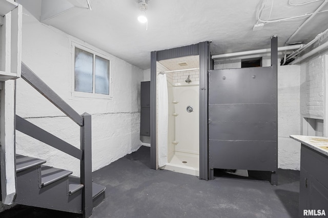 1803 W Barker Ave, Peoria, IL 61606 - bathroom featuring unfinished concrete floors, a stall shower, and vanity