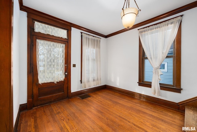 1803 W Barker Ave, Peoria, IL 61606 - entrance foyer with wood finished floors, crown molding, and baseboards
