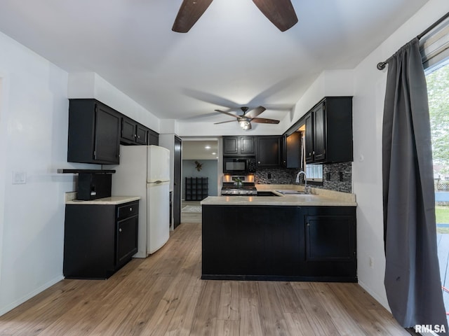 106 N 5th St, Dunlap, IL 61525 - kitchen featuring ceiling fan, black microwave, dark cabinetry, and freestanding refrigerator