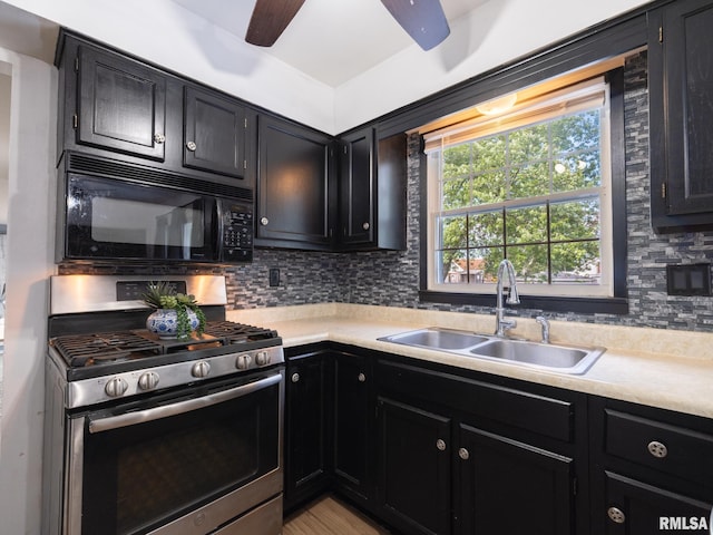 106 N 5th St, Dunlap, IL 61525 - kitchen featuring stainless steel range with gas cooktop, black microwave, dark cabinetry, and ceiling fan