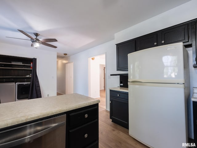 106 N 5th St, Dunlap, IL 61525 - kitchen featuring freestanding refrigerator, separate washer and dryer, dark cabinetry, stainless steel dishwasher, and light wood-style flooring
