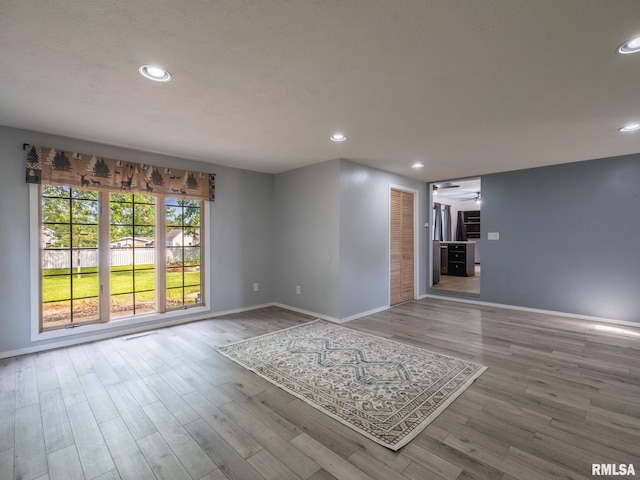 106 N 5th St, Dunlap, IL 61525 - unfurnished living room featuring wood finished floors and recessed lighting