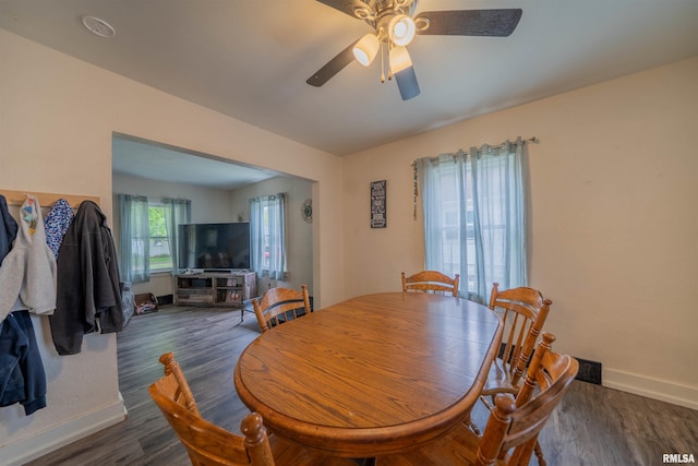dining room featuring ceiling fan, wood finished floors, and baseboards