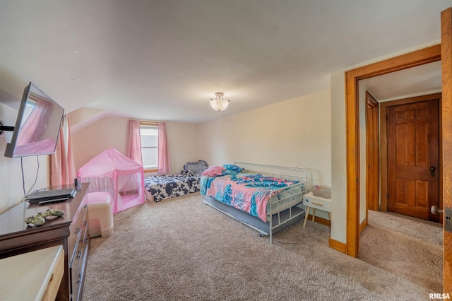 bedroom with carpet flooring and vaulted ceiling