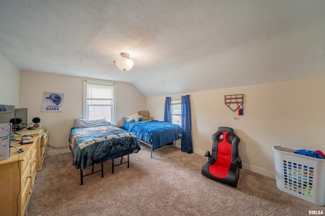 carpeted bedroom featuring vaulted ceiling, a textured ceiling, and baseboards