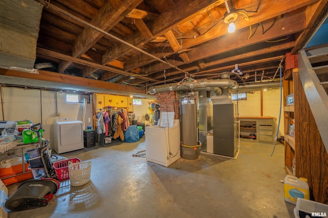 below grade area with gas water heater, heating unit, and washing machine and clothes dryer