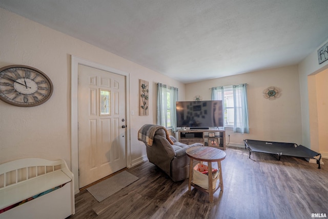 living area with wood finished floors and baseboards
