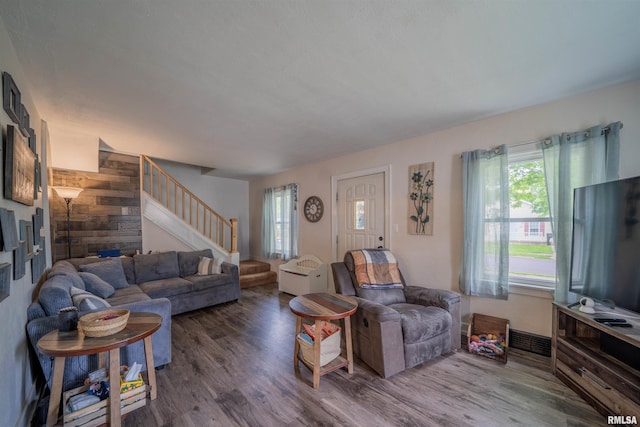 living area with stairway and wood finished floors