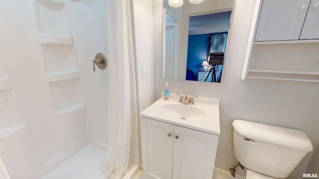 bathroom featuring a shower stall, vanity, and toilet