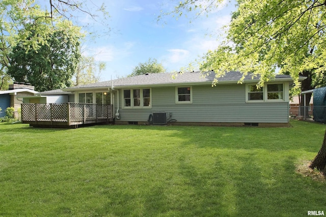 rear view of house with central AC unit, a yard, and a deck