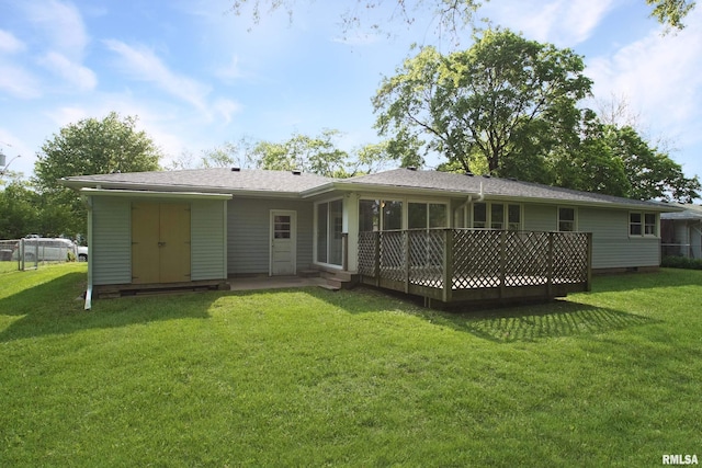 rear view of house featuring a yard and a sunroom